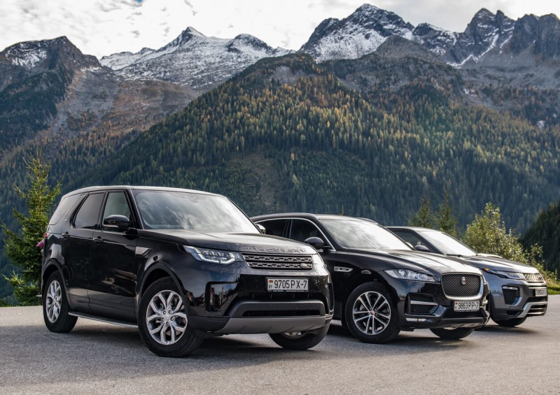 Land Rover and Jaguar SUVs in front of mountains
