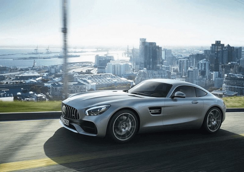 Silver Mercedes GT with city in background