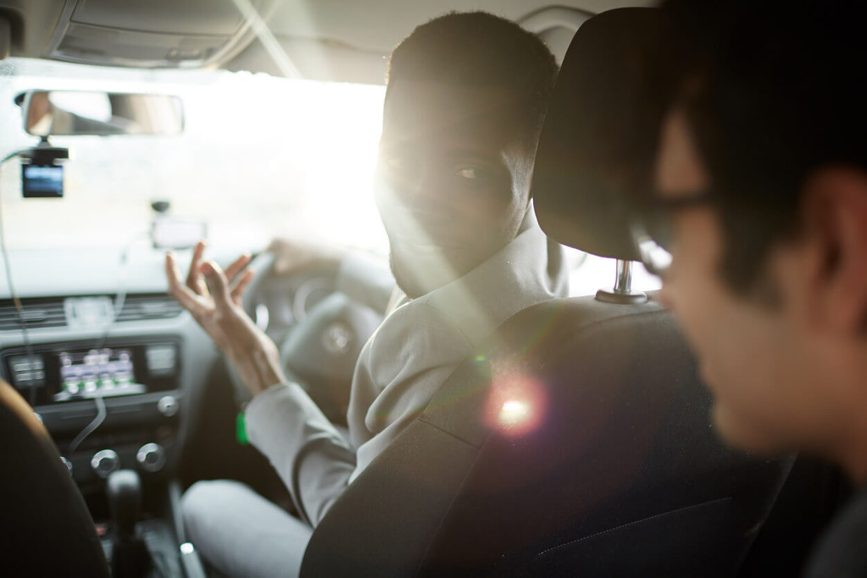 Driver talking to passenger behind him