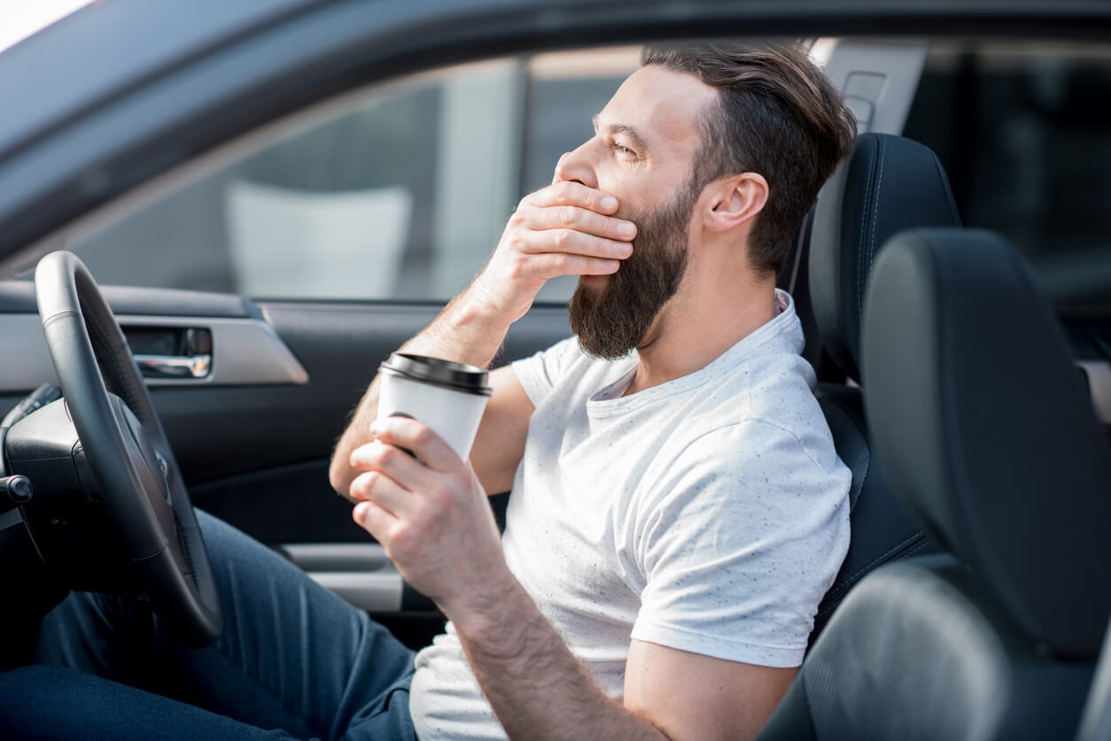 Man yawning while driving