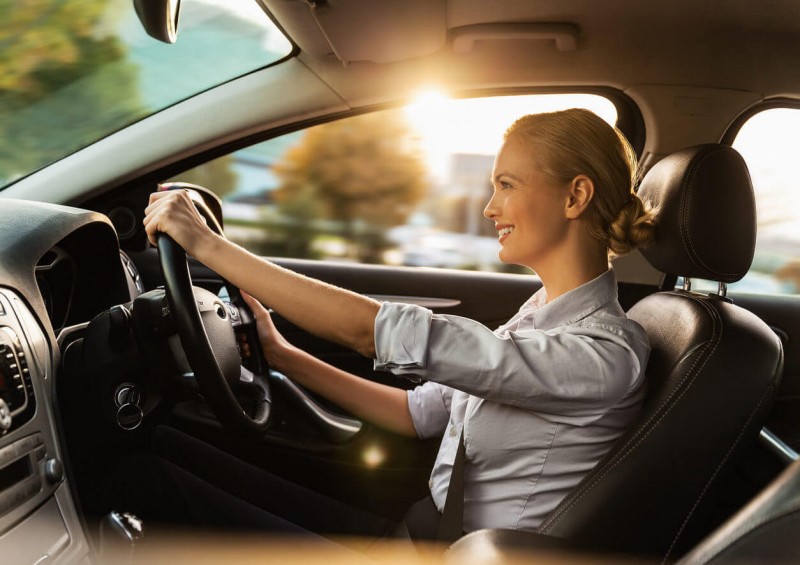 Business woman driving a new car