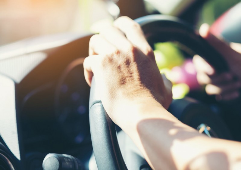 Close up of hand on steering wheel