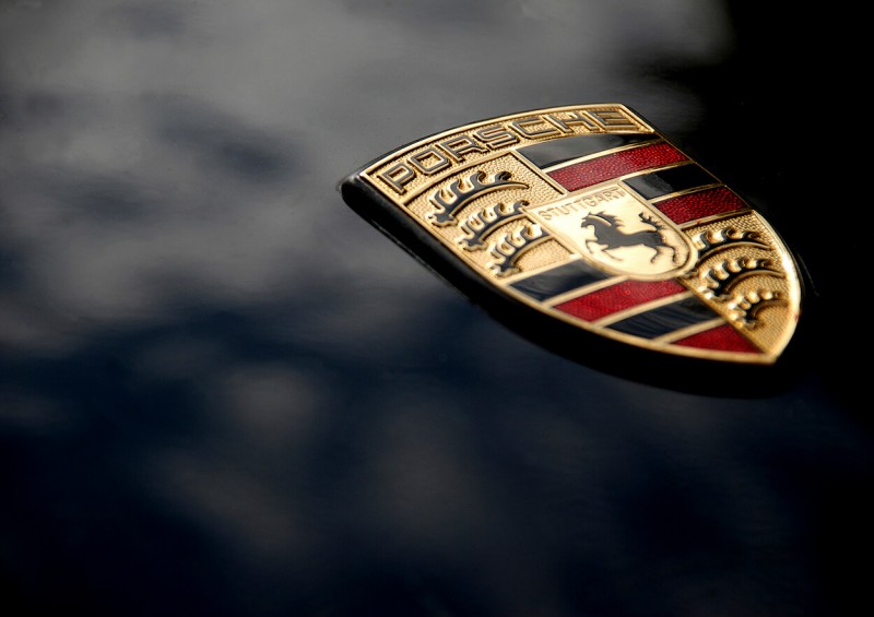 Close up of Porsche badge on car