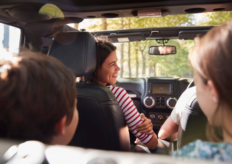 Dad driving with the children in the back