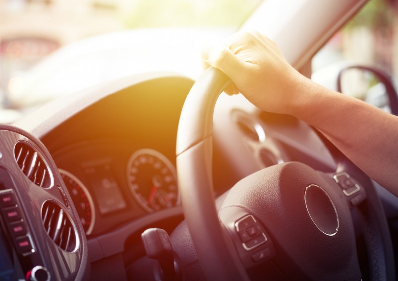 Drivers hand on steering wheel