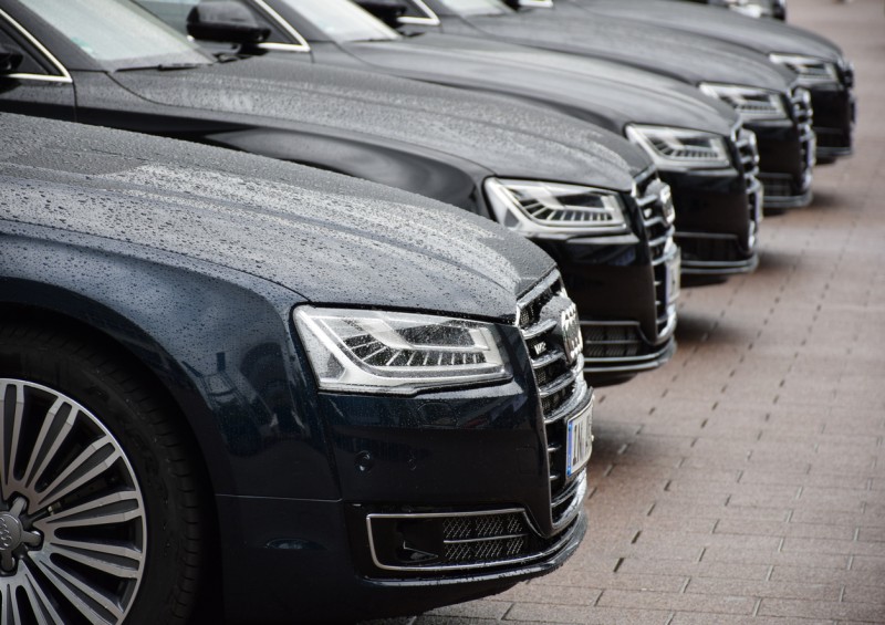 Five black audi cars in a row