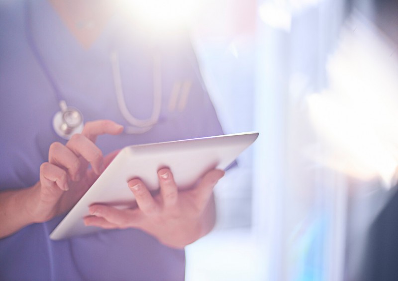 NHS nurse looking on ipad