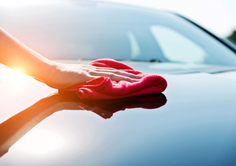 Person polishing car bonnet