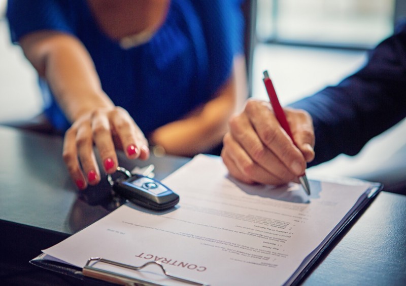 Person signing car contract Person signing car contract