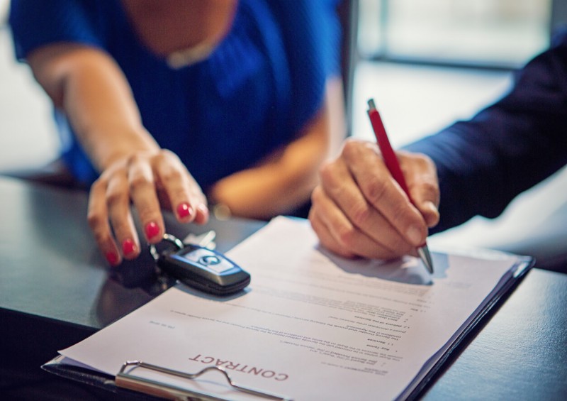 Person signing car contract