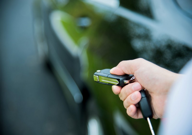 Person with car keys and new car