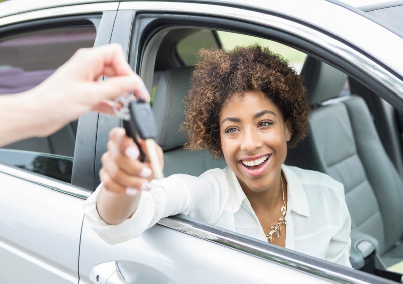 Young driver receiving new car keys